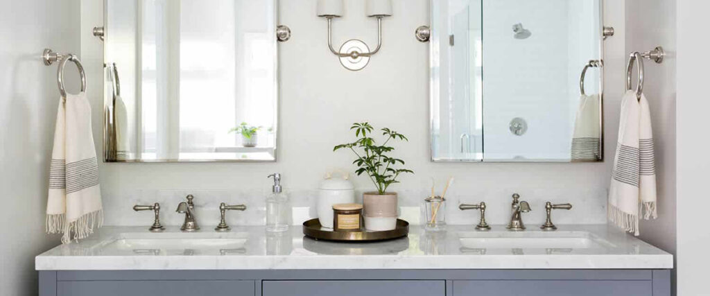 a bathroom vanity with two sinks and two mirrors